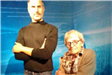 Woman Posing for Photo with Wax Figure of Steve Jobs