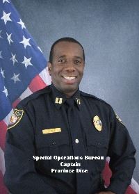 Headshot of Prurince Dice in front of an American Flag